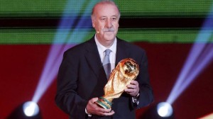 Spain's coach Vicente del Bosque holds the World Cup trophy on stage during the draw for the 2014 World Cup at the Costa do Sauipe resort in Sao Joao da Mata, Bahia state, December 6, 2013. (Reuters)
