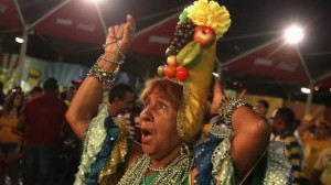 A woman watches the Confederation Cup match between Brazil and Mexico on a television in Rio de Janeiro on June 19. (PILAR OLIVARES/REUTERS)